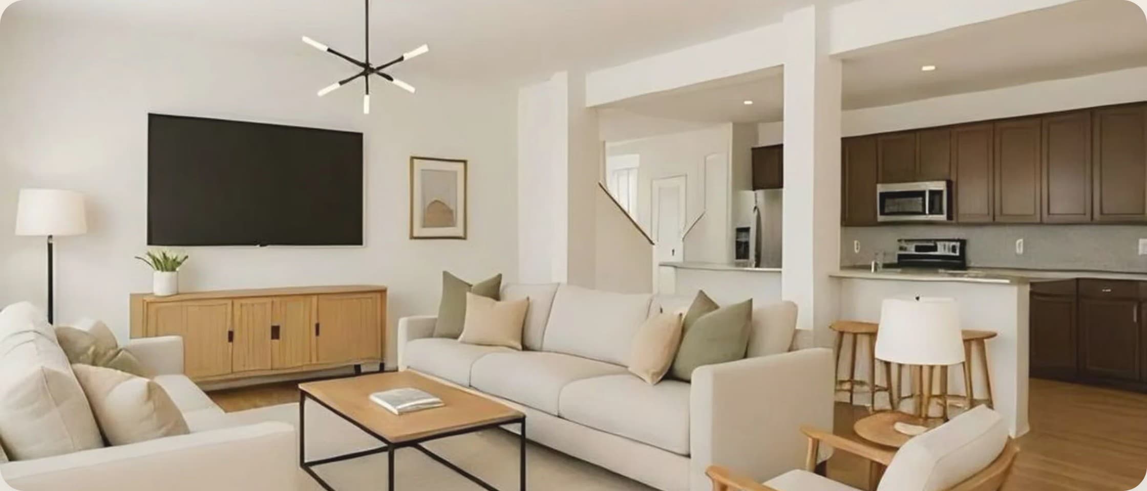 The furnished living space: open-plan living room opening into the kitchen.